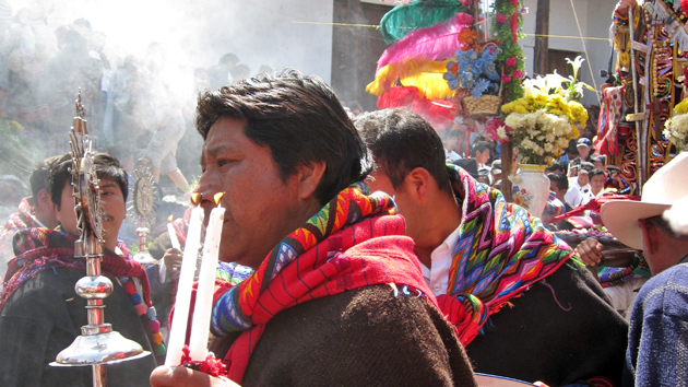 Cofradía leaders, clad in traditional dress, carry incense, candles, and a ceremonial staff topped with a silver badge, a symbol of the Sun and their patron saint. To be a Cofradía member demands great responsibility, effort, and personal expense. &nbsp;<span class='italic'>Photo Credit:&nbsp;Isabel Hawkins</span>